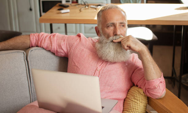 istock Senior man  at home and using laptop 1205449890