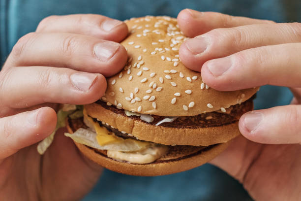istock Male hands holding a fresh Burger. Fast food. 1205452499
