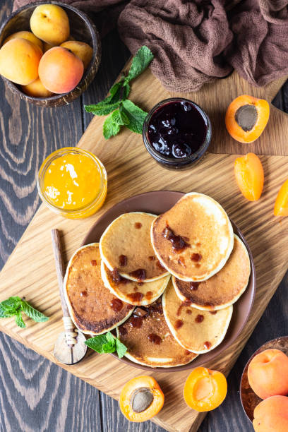 istock Pancakes with jam, apricot and mint. Delicious dessert for breakfast. 1205452685