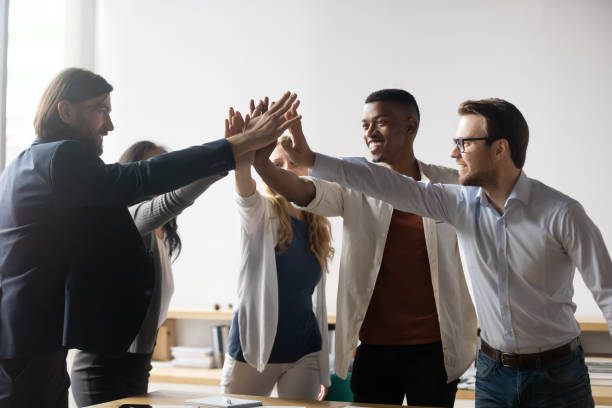 istock Excited successful diverse business people giving high five, celebrating win 1205454401