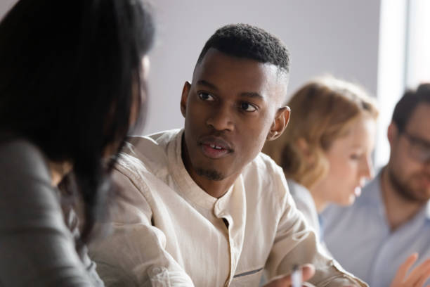 istock African American mentor coach training teaching intern, talking to coworker 1205454413
