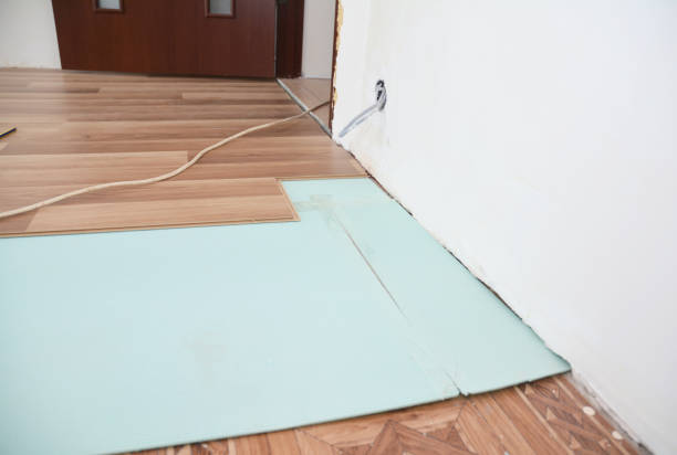 istock Installing wooden laminate flooring with insulation and soundproofing sheets. 1205456945