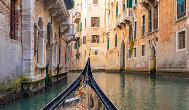pov from a gondola on a canal in venice, italy - veneziana imagens e fotografias de stock
