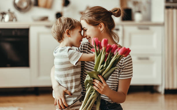 happy mother's day! child son gives flowers for  mother on holiday - mother enjoyment built structure human head imagens e fotografias de stock