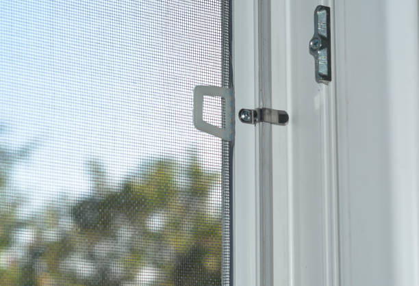 Close-up on mosquito wire screen installation on a window to protect from flies, mosquitos and other insects.