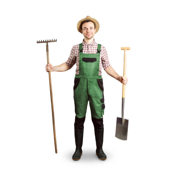 istock Happy gardener holding a rake and a spade 1205461222