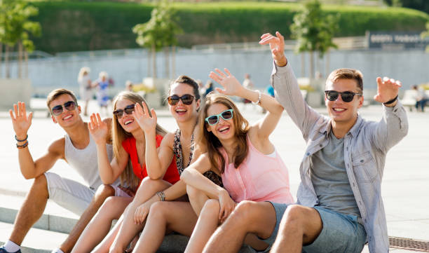 istock group of laughing friends sitting on city square 1205463627
