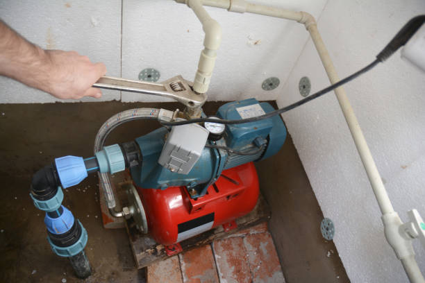 istock Contractor installing and repairing water pumping station. Borehole water pump. 1205465265
