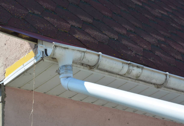 istock Broken roof gutter needs repairing. Close-up on a rain gutter damage on house asphalt shingles roof. 1205466761