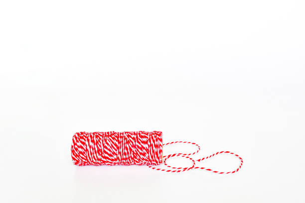 istock Rope in red and white roll, twine rope spool for tight packaing or parcel, color special decorate christmas present's box on white background with space for text. 1205467123