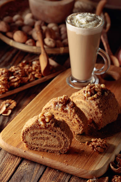 istock Walnut cake and coffee latte with cream on a wooden table. 1205467145