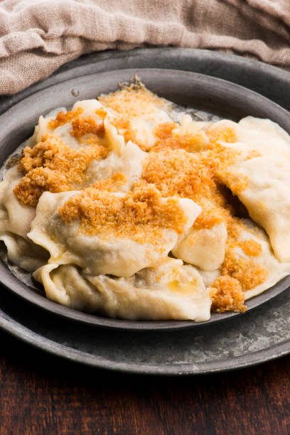 istock Boiled pierogi (Polish dumplings) stuffed with cabbage and mushrooms 1205467157