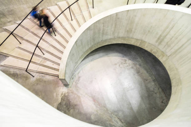 istock Blurred Motion of Person on Spiral Staircase 1205467181