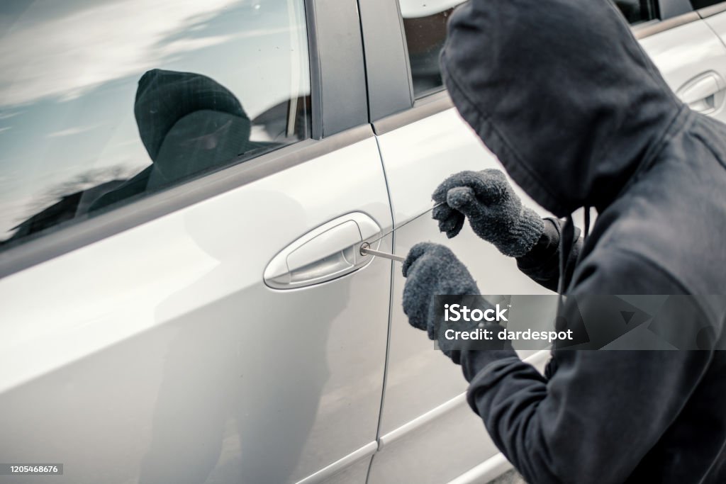 Man stealing a car Stealing - Crime Stock Photo