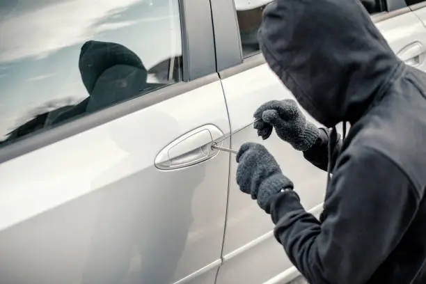 Photo of Man stealing a car