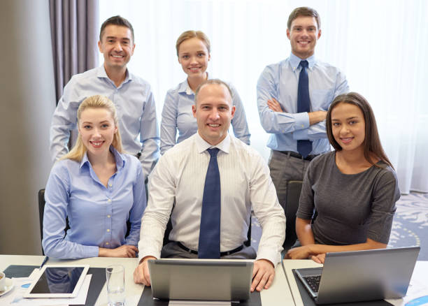 istock smiling business people with laptop in office 1205470052