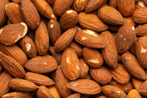 istock Many beautiful almond nuts as a background 1205470246