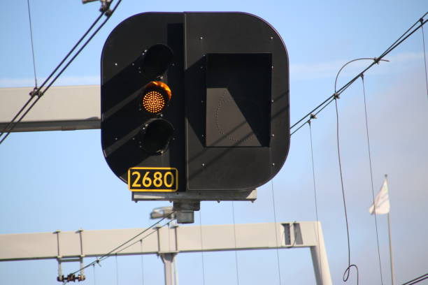 istock Orange light sign above the rails to let train drivers use low speed at Utrecht Central Station 1205471614