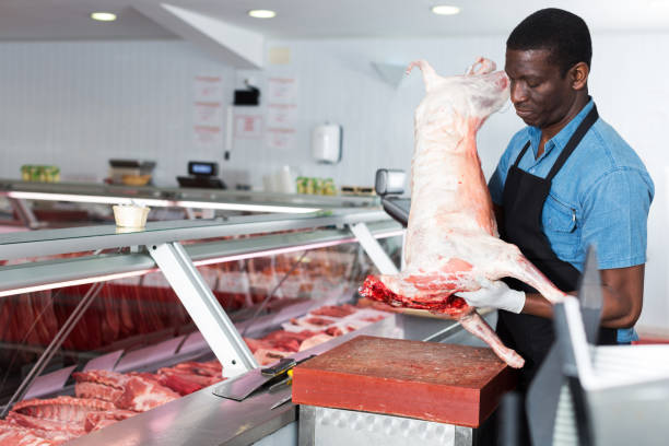 istock African American male butcher processing carcase of lamb 1205473459