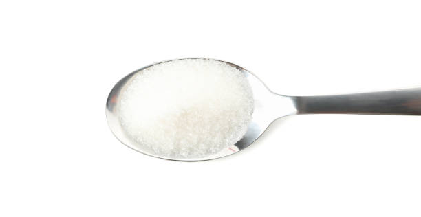 istock Spoon with sugar isolated on white background, close up 1205473729
