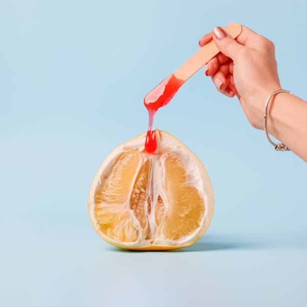 istock Half pomelo citrus and liquid wax. 1205475106
