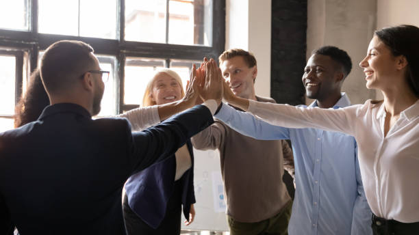 istock Group successful multiethnic workmates giving high five celebrating career growth 1205475142
