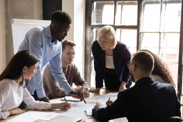 istock Diverse staff engaged at financial stats information analysis at meeting 1205475155