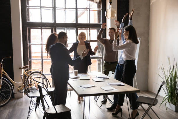 istock Six happy and excited multi-ethnic staff celebrating project accomplishment 1205475159