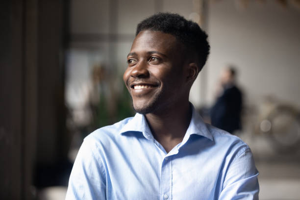 istock Happy African ethnicity businessman standing in modern workspace feels satisfied 1205475173