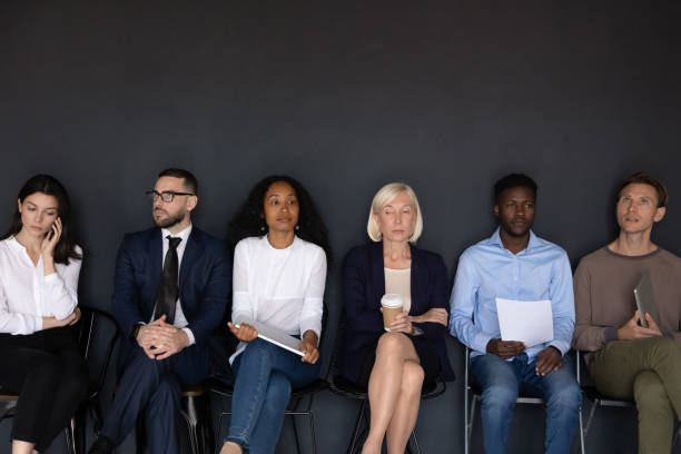 istock Multicultural applicants waiting turn for job interview seated on chairs 1205475179