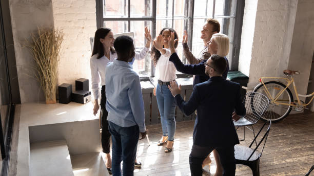 istock Diverse workers giving high five gesture of partnership and synergy 1205475208