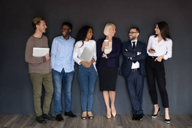 istock Diverse successful company representatives standing leaned on black wall background 1205475211