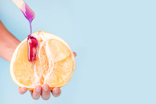 istock Half pomelo citrus and liquid wax. 1205475324