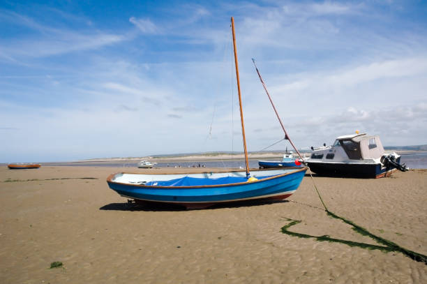 istock Sail boat moored with an anchor on the beach at low tide at Appledore beach North Devon 1205478936