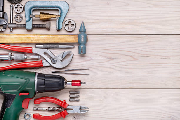 istock Set of various home tools lying in row on light wooden background. Men's style 1205479149