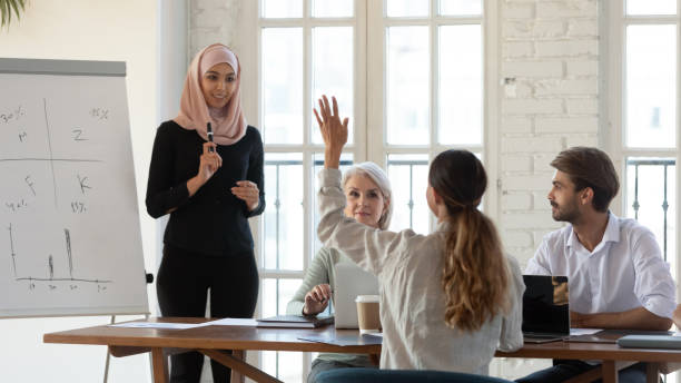 istock Arabic female speaker interact with employees at meeting 1205480356