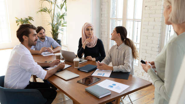istock Multiracial colleagues discuss ideas at office briefing 1205480359