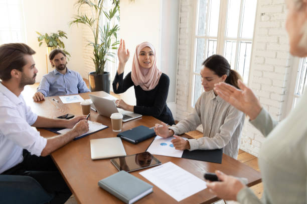 istock Motivated Arabic female employee participate in group discussion 1205480370