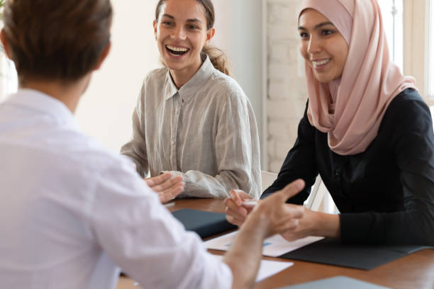 istock Happy multiracial employees laugh discussing ideas at meeting 1205480399