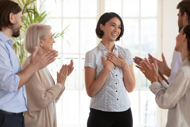 istock Overjoyed colleagues applaud Korean team leader greeting with success 1205480464