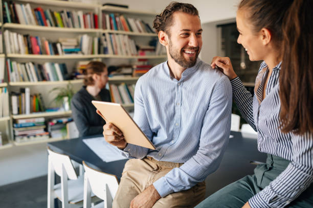 istock Working together on project. Happy young business colleagues working in office 1205480681