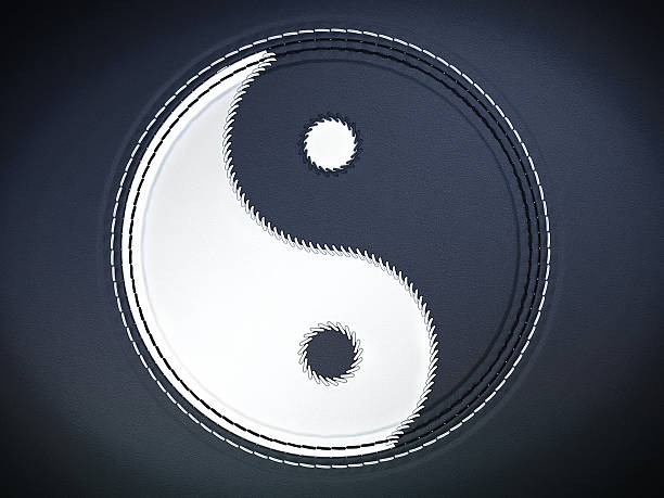 Yin yan stitched symbol on dark blue leather background