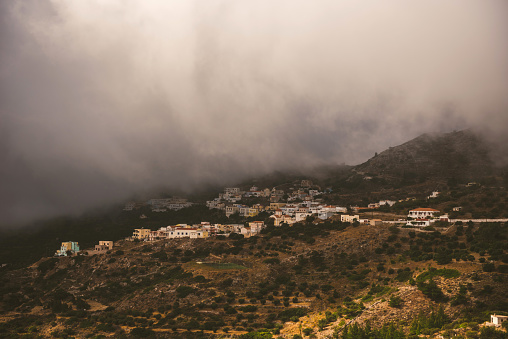 The village of Othos is a picturesque traditional mountain village located at the highest point of Karpathos, at an altitude of about 500 meters. It is located about 12 kilometers northwest of the capital Karpathos Town or Pigadia. Stormy clouds oer this village