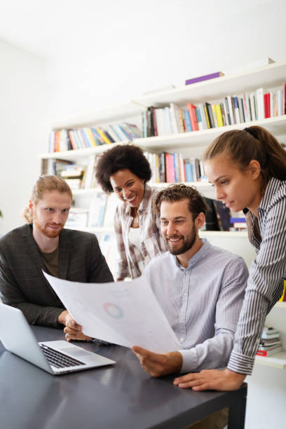 istock Group of business people collaborating on project in office 1205481113
