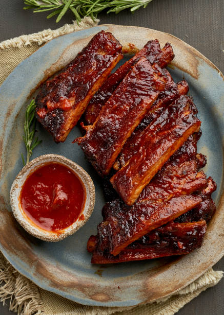 Keto food, spicy barbecue pork ribs. Slow cooking recipe. Vertical, cloe up, stock photo