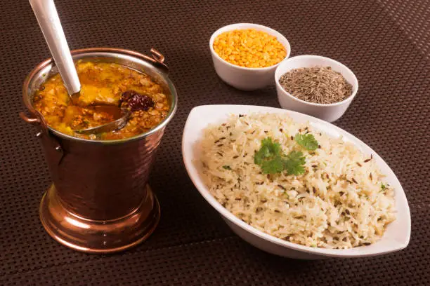 Indian Traditional dal fry and jeera rice also known as dal chawal, cooked lentils served with cumin seed rice