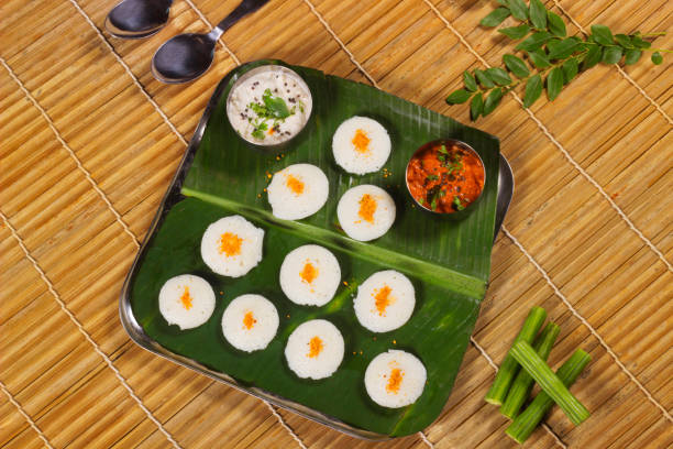 istock Plain rava idli with chutney served on banana leaf 1205482287