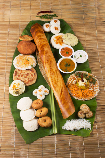 Traditional South Indian snacks, Dosa, idli, medu wada on banana leaf.