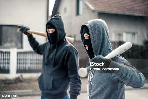 Young Men Holding A Baseball Bat Symbolizing Crime Stock Photo - Download Image Now - Baseball Bat, Men, Violence