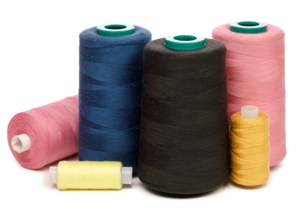 istock Group of spools of color sewing threads on white background 1205484159